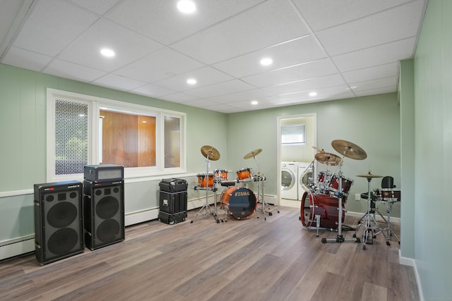 101 Rosengarten Dr, Waterbury, CT 06704 - playroom featuring independent washer and dryer, wood finished floors, a baseboard heating unit, recessed lighting, and baseboards