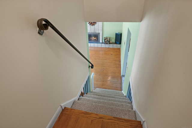 101 Rosengarten Dr, Waterbury, CT 06704 - staircase featuring a brick fireplace, baseboards, and wood finished floors
