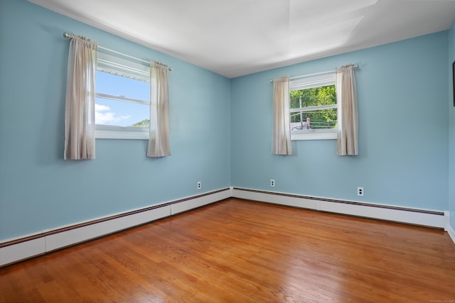 101 Rosengarten Dr, Waterbury, CT 06704 - empty room featuring wood finished floors, a baseboard heating unit, and baseboard heating