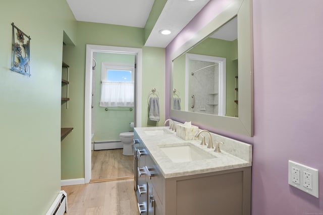 101 Rosengarten Dr, Waterbury, CT 06704 - bathroom featuring a baseboard radiator, toilet, double vanity, wood finished floors, and recessed lighting