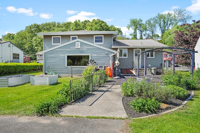 101 Rosengarten Dr, Waterbury, CT 06704 - back of property with a garden and a yard