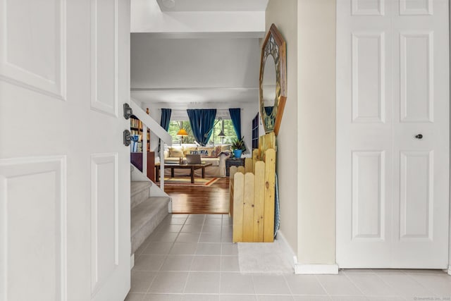 9 Lower Commons Unit 9, Woodbury, CT 06798 - hallway featuring tile patterned flooring, stairs, and baseboards