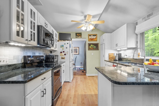9 Lower Commons Unit 9, Woodbury, CT 06798 - kitchen featuring double oven range, stainless steel microwave, a sink, freestanding refrigerator, and tasteful backsplash