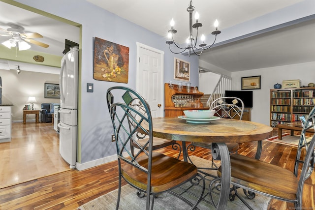 9 Lower Commons Unit 9, Woodbury, CT 06798 - dining area featuring stairway, light wood finished floors, ceiling fan, a chandelier, and baseboards