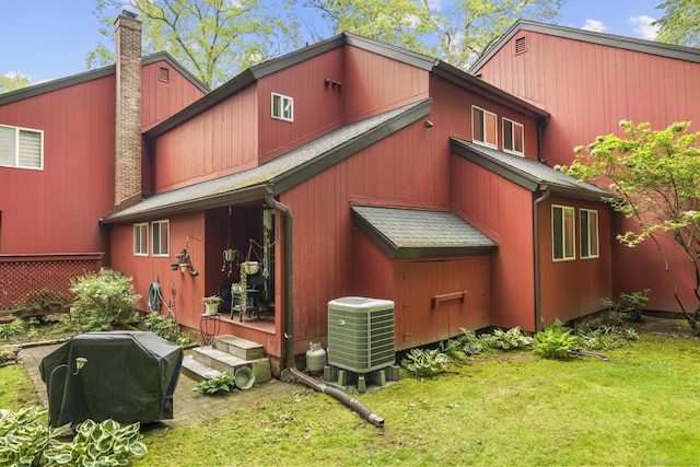 9 Lower Commons Unit 9, Woodbury, CT 06798 - rear view of house featuring a chimney, cooling unit, and a yard
