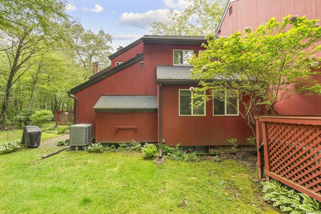 9 Lower Commons Unit 9, Woodbury, CT 06798 - view of side of home with roof with shingles, central air condition unit, a yard, and a chimney