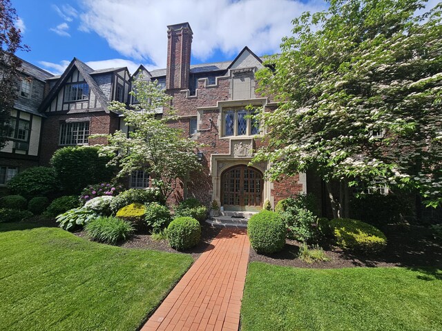 182 Fern St Apt 4, West Hartford, CT 06119 - view of front of property featuring a front yard, brick siding, and a chimney