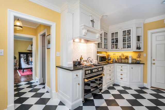 182 Fern St Apt 4, West Hartford, CT 06119 - kitchen with range with gas cooktop, dark floors, stainless steel microwave, dark countertops, and white cabinets