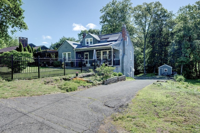 21 Elm St, Southington, CT 06479 - bungalow-style home with a chimney, roof mounted solar panels, stucco siding, and asphalt driveway