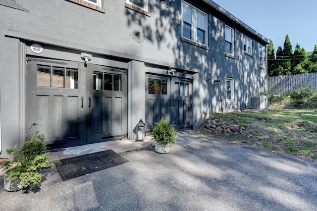 21 Elm St, Southington, CT 06479 - entrance to property with central air condition unit, stucco siding, a patio area, and french doors