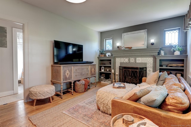 21 Elm St, Southington, CT 06479 - living area featuring a tiled fireplace, wood finished floors, and baseboards