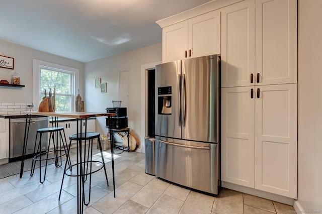 21 Elm St, Southington, CT 06479 - kitchen featuring appliances with stainless steel finishes, open shelves, white cabinetry, and light tile patterned floors