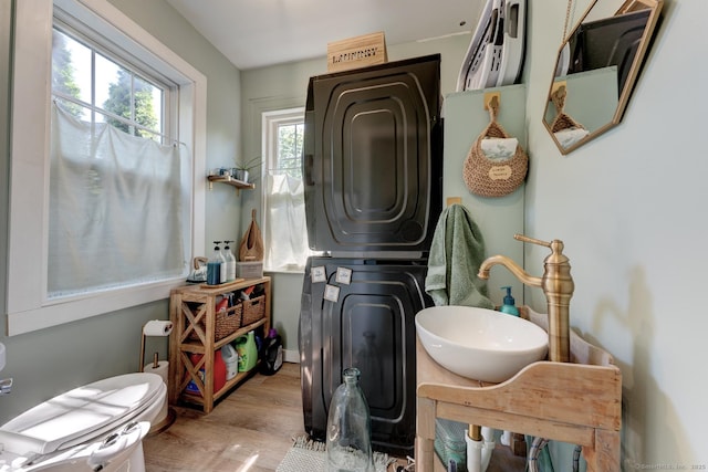 21 Elm St, Southington, CT 06479 - bathroom featuring stacked washer / dryer, wood finished floors, and vanity