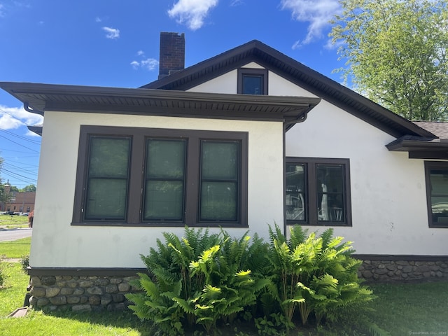 66 Seymour Ave, Derby, CT 06418 - view of side of property featuring stucco siding and a chimney