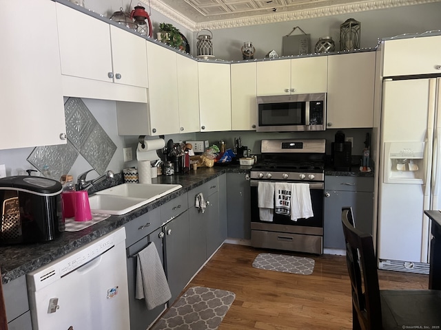 66 Seymour Ave, Derby, CT 06418 - kitchen with stainless steel appliances, a sink, wood finished floors, and dark countertops