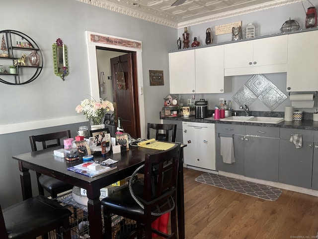 66 Seymour Ave, Derby, CT 06418 - kitchen with white dishwasher, an ornate ceiling, dark countertops, dark wood-style flooring, and white cabinetry