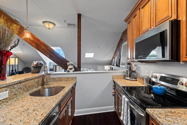 461 Bank St Unit 410, New London, CT 06320 - kitchen with appliances with stainless steel finishes, a sink, dark wood finished floors, light stone counters, and lofted ceiling
