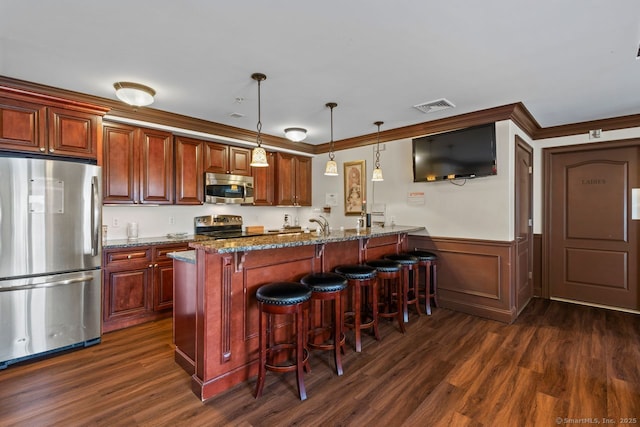 461 Bank St Unit 410, New London, CT 06320 - kitchen featuring stainless steel appliances, a kitchen breakfast bar, dark wood finished floors, a peninsula, and wainscoting