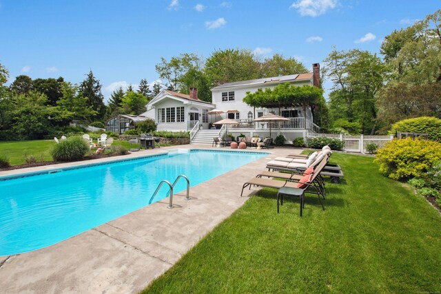 19 Pheasant Ridge Rd, Redding, CT 06896 - view of swimming pool with stairway, a wooden deck, view of scattered trees, and a patio area