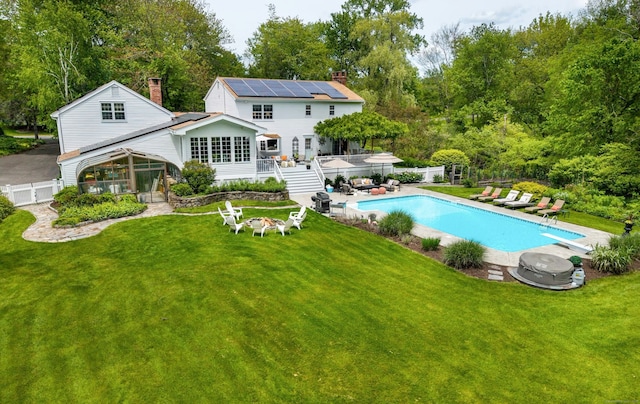19 Pheasant Ridge Rd, Redding, CT 06896 - rear view of property featuring a chimney, a gazebo, solar panels, a wooden deck, and a patio area