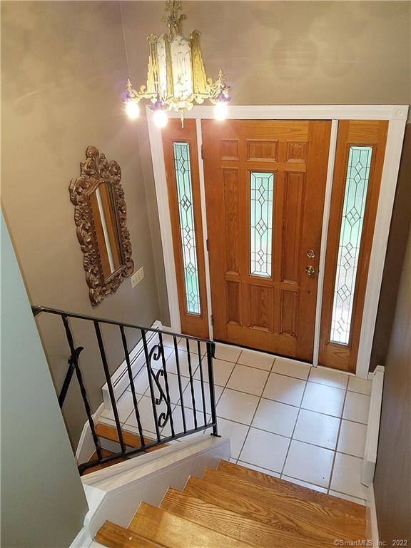 3 Abbey Ln, Shelton, CT 06484 - tiled entrance foyer featuring a chandelier and stairway