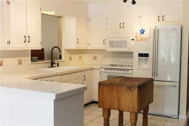 3 Abbey Ln, Shelton, CT 06484 - kitchen with white appliances, a sink, tile counters, light tile patterned floors, and white cabinets