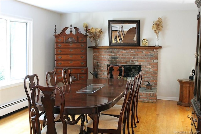 3 Abbey Ln, Shelton, CT 06484 - dining area with light wood-style floors, a fireplace, a baseboard radiator, and baseboards