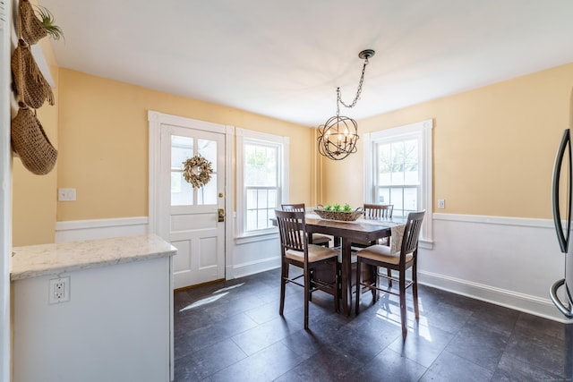 36 Whiton St, Windsor Locks, CT 06096 - dining room with a chandelier, healthy amount of natural light, baseboards, and dark tile patterned flooring