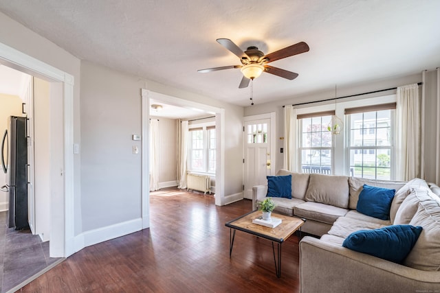 36 Whiton St, Windsor Locks, CT 06096 - living room with radiator, ceiling fan, dark wood-style flooring, and baseboards