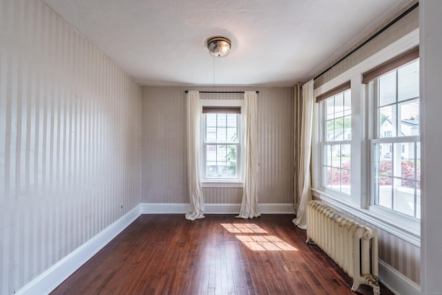 36 Whiton St, Windsor Locks, CT 06096 - unfurnished room featuring radiator, dark wood-style floors, healthy amount of natural light, and baseboards