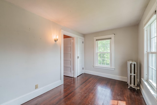 36 Whiton St, Windsor Locks, CT 06096 - empty room with radiator, dark wood-style floors, and baseboards