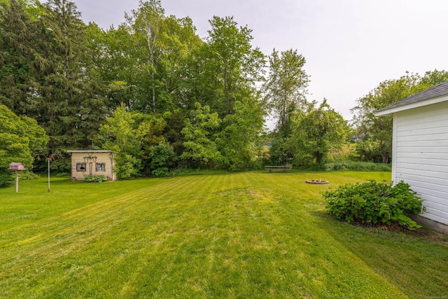 36 Whiton St, Windsor Locks, CT 06096 - view of grassy yard featuring an outdoor structure and a fire pit