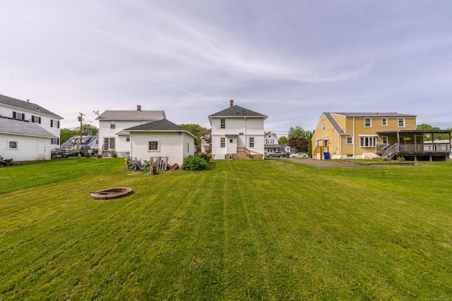 36 Whiton St, Windsor Locks, CT 06096 - view of green lawn with an outdoor fire pit and a deck