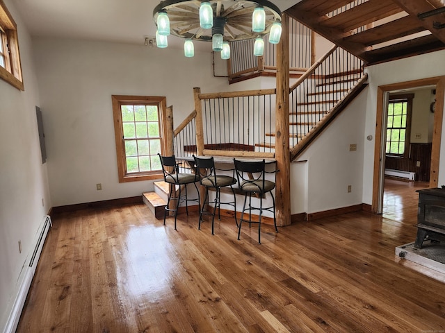 749 W Rd, Salem, CT 06420 - dining area featuring a baseboard heating unit, ceiling fan, stairs, a wood stove, and baseboard heating
