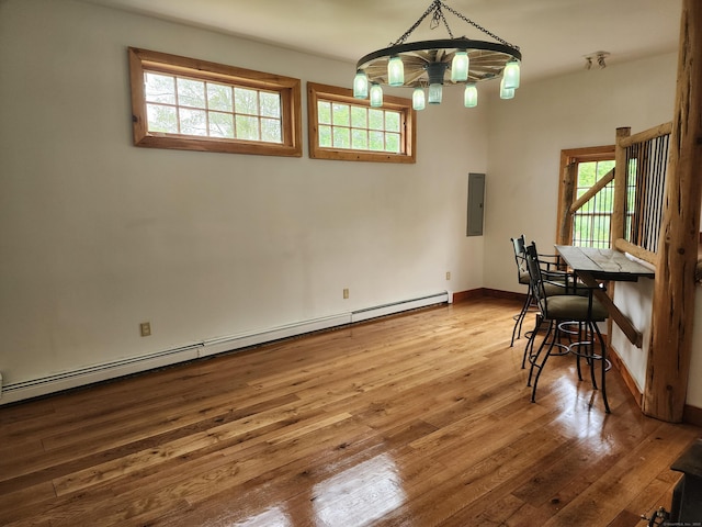 749 W Rd, Salem, CT 06420 - dining room featuring a chandelier, a baseboard radiator, hardwood / wood-style flooring, and electric panel