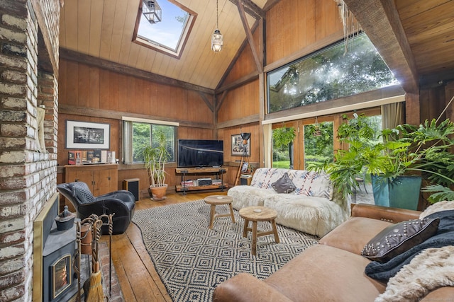 18 Grey Fox Trl, Woodbury, CT 06798 - living room featuring hardwood / wood-style floors, high vaulted ceiling, wood walls, a skylight, and wooden ceiling