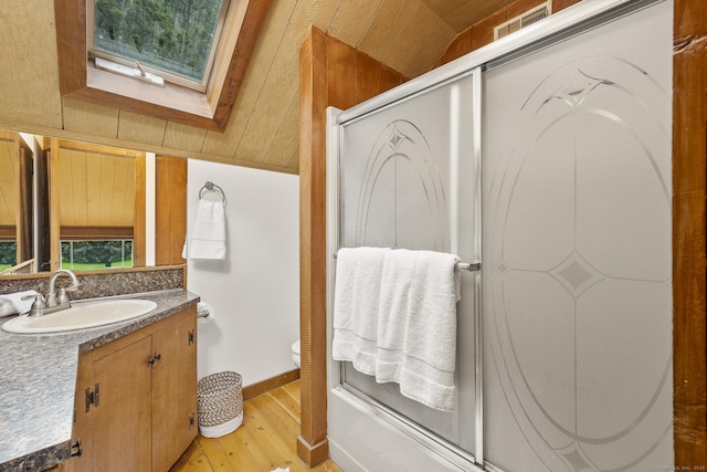 18 Grey Fox Trl, Woodbury, CT 06798 - full bath featuring wood finished floors, vanity, toilet, a skylight, and baseboards