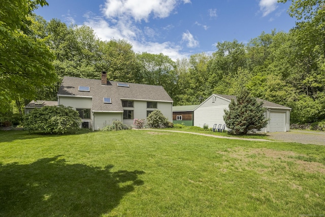 18 Grey Fox Trl, Woodbury, CT 06798 - view of front of home featuring a front lawn, a chimney, roof with shingles, and a garage