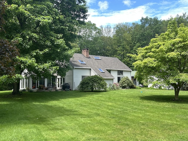 18 Grey Fox Trl, Woodbury, CT 06798 - view of front facade with a shingled roof, a front yard, and a chimney