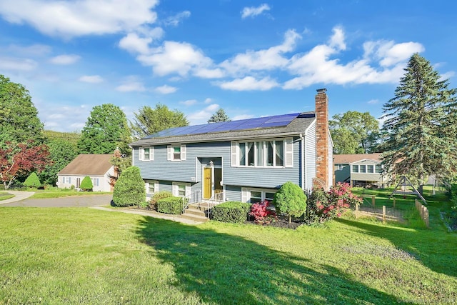 278 High St, Bristol, CT 06010 - split foyer home with a chimney, a front lawn, and roof mounted solar panels
