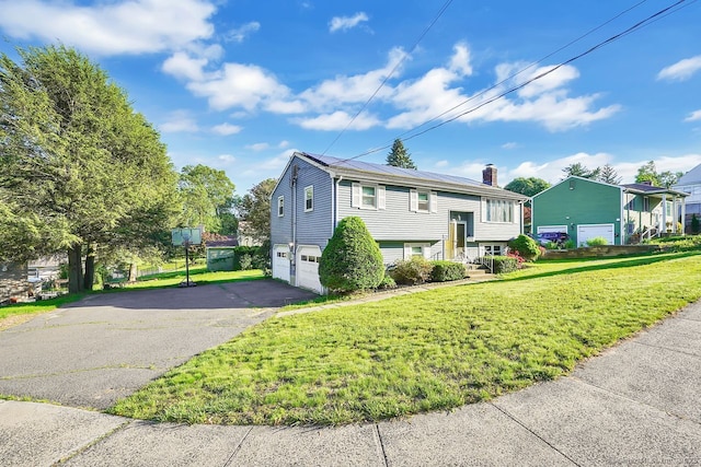278 High St, Bristol, CT 06010 - bi-level home featuring asphalt driveway, an attached garage, a front yard, and a chimney