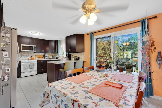 278 High St, Bristol, CT 06010 - kitchen with stainless steel appliances, dark brown cabinets, backsplash, and ceiling fan