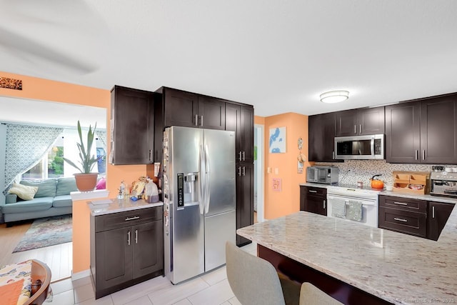 278 High St, Bristol, CT 06010 - kitchen with stainless steel appliances, dark brown cabinetry, and backsplash