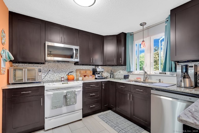 278 High St, Bristol, CT 06010 - kitchen featuring appliances with stainless steel finishes, a sink, decorative backsplash, a textured ceiling, and hanging light fixtures