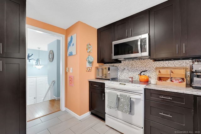 278 High St, Bristol, CT 06010 - kitchen featuring stainless steel microwave, white range with electric stovetop, decorative backsplash, baseboards, and light stone countertops