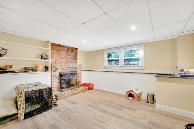 278 High St, Bristol, CT 06010 - unfurnished living room with wood finished floors, a brick fireplace, baseboards, and a drop ceiling