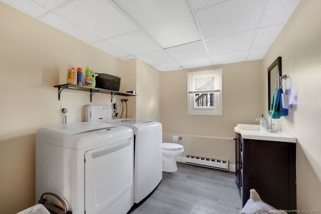 278 High St, Bristol, CT 06010 - laundry area featuring a baseboard heating unit, washer and dryer, and wood finished floors