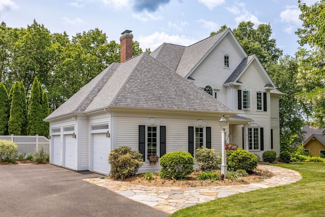 66 Great Pond Rd, Glastonbury, CT 06073 - view of front of house featuring a shingled roof, asphalt driveway, a chimney, and a garage