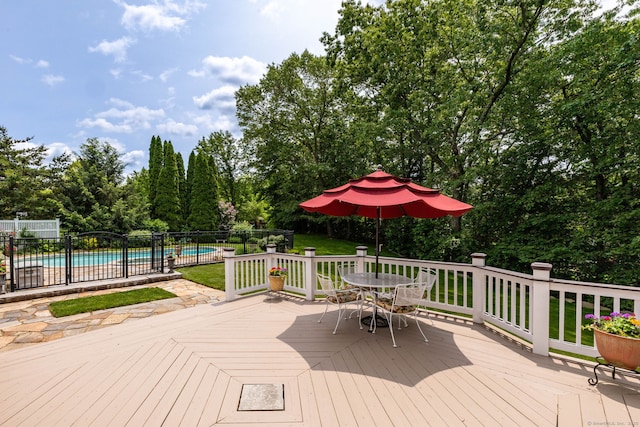 66 Great Pond Rd, Glastonbury, CT 06073 - wooden deck with outdoor dining space and view of wooded area