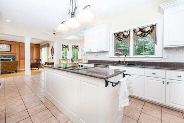 66 Great Pond Rd, Glastonbury, CT 06073 - kitchen with a sink, black electric stovetop, light tile patterned flooring, a kitchen island, and ornate columns